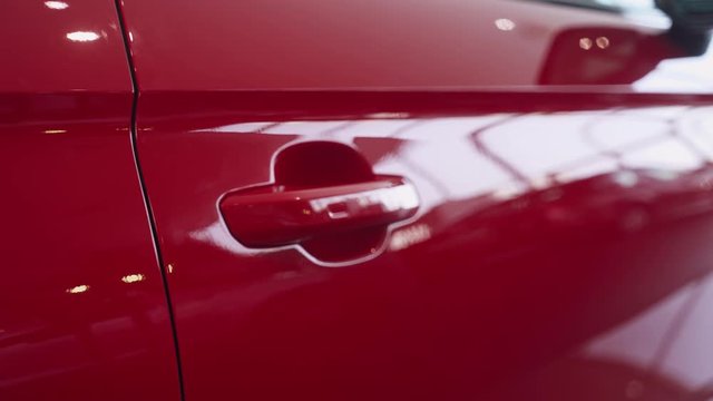 Modern car, view of red car exterior, smooth camera movement.
