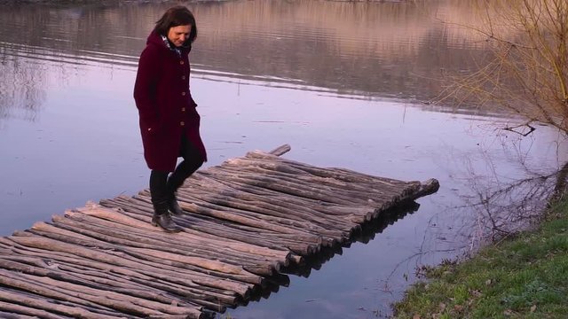 Romantic woman on a old bridge and looking at her