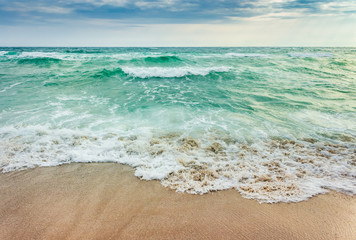 crushing waves on sandy beach. weather before the morning storm