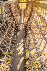 wooden bridge with strong robe at playground in school.
