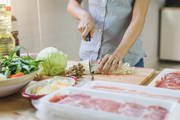 Young asian woman cutting vegetable in the kitchen