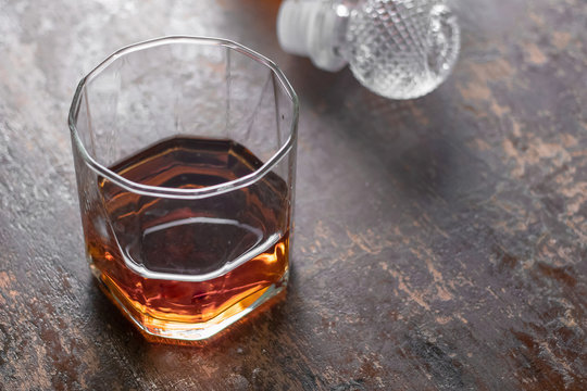 Bottle whiskey and Glass of whiskey on black background