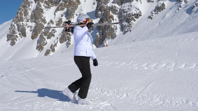 A Skier Go Forward With Downhill Ski On Ner Shoulder