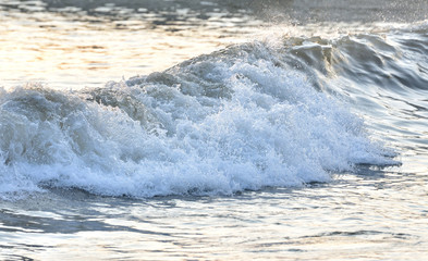 Beautiful dynamic wave in the sea with spray. Evening sea