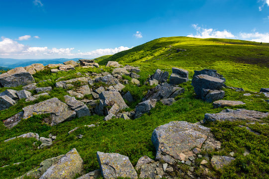 huge rocky formation on the grassy hillside. beautiful landscape of Runa mountain on a bright summer day