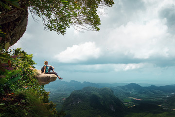 Hiker rest on a cliff,woman enjoy landscape of nature - Powered by Adobe