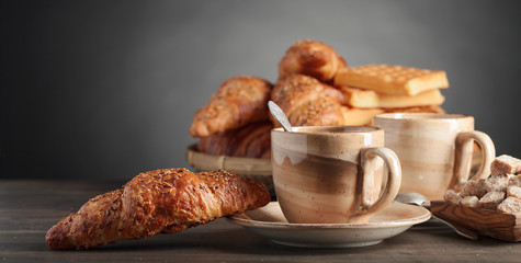 Breakfast with black coffee and fresh pastries.
