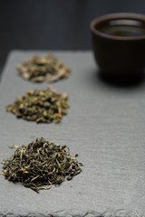 Fototapeta na wymiar Dry tea collection of different types on black background