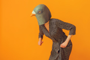 Woman funny portrait wearing pigeon mask