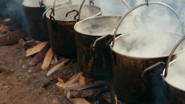 Preparation of food in boilers on an open fire in a traditional style, Spain