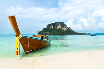 Fototapeta na wymiar Longtail boat on tropical beach and limestone rock, Mu Koh Poda, Krabi, Thailand