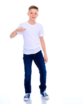 A school boy points to his white T-shirt.