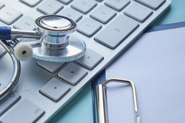 Stethoscope with clipboard and Laptop on desk,Doctor working in hospital writing a prescription,