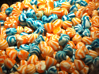 Close up of bowls filled with a large selection of different colored soft candies