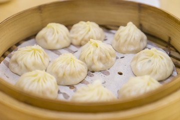Fototapeta na wymiar Yummy dumplings in a bamboo steamer box