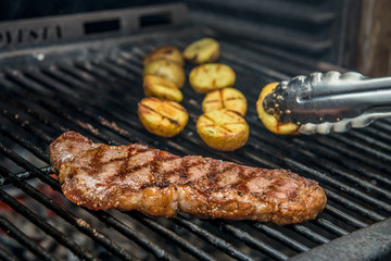 Steak New York Being Prepared in Josper