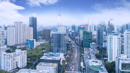 Fototapeta premium Traffic on busy road with high buildings