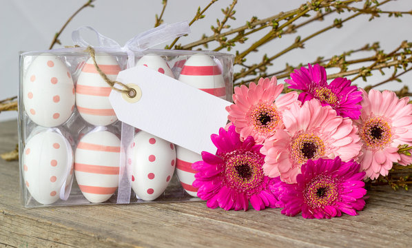 Easter eggs with dots and stripes with pink gerbera and white copy space