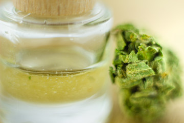 Medical Oil Cannabis - marijuana flowers on the wooden stopper with cannabis oil  bottles.