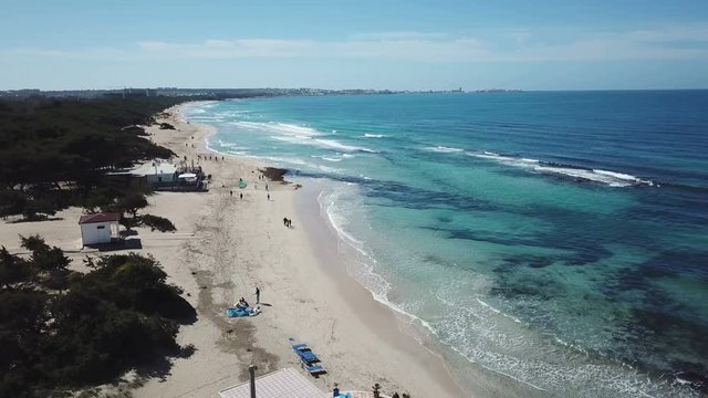 Aerial view of sandy beach and ocean with waves - drone cinematic 4k view