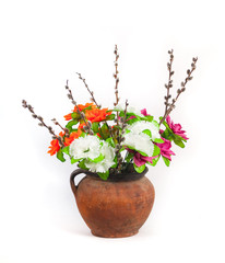Bouquet in an old jug. Isolated on a white background