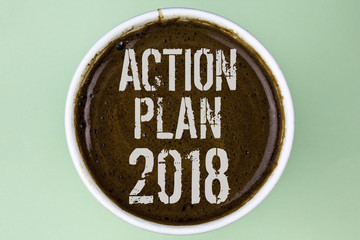 Word writing text Action Plan 2018. Business concept for Plans targets activities life goals improvement development written on Coffee in a Cup on the plain background.