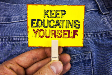 Word writing text Keep Education Yourself. Business concept for Learning skills with your own competencies written on Yellow Sticky Note Paper holding by man with Clip on Jeans background