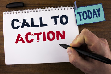Handwriting text writing Call To Action. Concept meaning most important part of online digital marketing campaign written by Man on Notepad holding Marker on wooden background Today Clip. © A