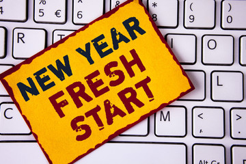 Handwriting text writing New Year Fresh Start. Concept meaning Time to follow resolutions reach out dream job written on Sticky note paper placed on White Keyboard. Top view.