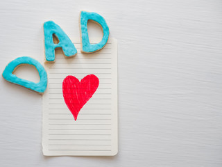 Sweet, cute kitten and the word DAD on a white, isolated background. Preparation for Father's Day