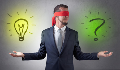 Covered eye businessman with bulb and question sign symbols around