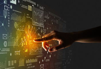 Female finger touching a beam of light surrounded by charts and graphs