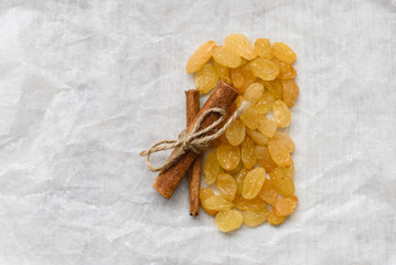 Fototapeta na wymiar Ingredients for sweet food golden raisins and cinnamon on white