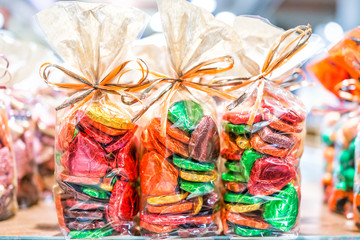 Colorful packaged wrapped chocolate hearts in candy store shop, green, golden, gold, yellow as...
