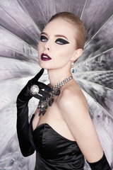 Woman with bright makeup and with set jewelry