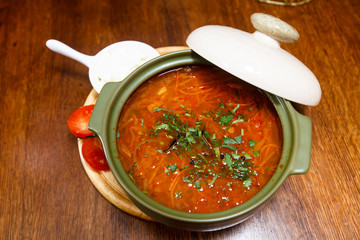 Traditional Russian borscht with bacon, sour cream and rye bread.