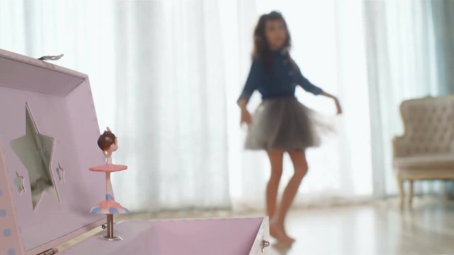 Music box with dancing rotating ballerina in front, dancing girl on the back, 4k