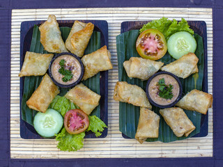 Fried spring rolls with vegetables and sauce. Close up. Asian food, Ubud, Bali, Indonesia.