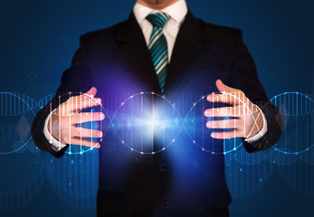 Businessman with DNA concept in his hands 