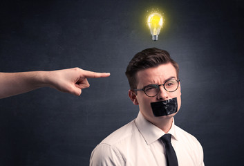 Caucasian hand pointing at businessman with a lightbulb above his head