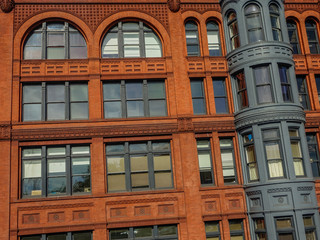 Seattle downtown, Washington, USA - October 5, 2015:  Classic red brick facade of vintage architecture with glass windows and iron structure