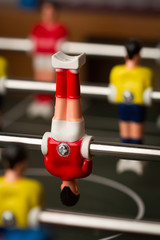 closeup of upside down football figurine on foosball table soccer game