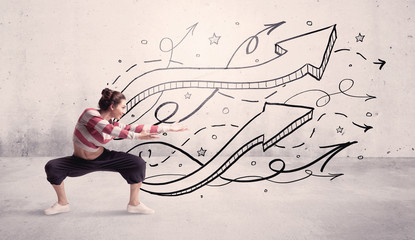 A beautiful young hip hop dancer dancing contemporary street dance in front of urban grey wall...