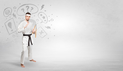 Young kung-fu trainer fighting with doodled symbols concept
