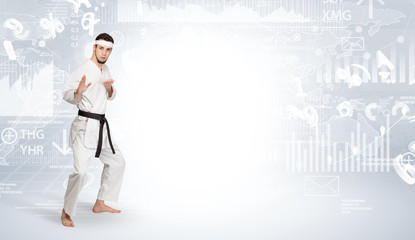 Young karate trainer doing karate tricks on the top of a metropolitan city
