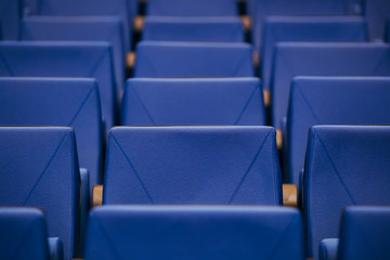 Many rows of empty armchairs. Blue, elite seats, comfortable armchairs. Conference room, theater or cinema.