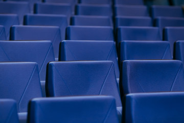 Naklejka premium Many rows of empty armchairs. Blue, elite seats, comfortable armchairs. Conference room, theater or cinema.