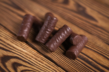 Heap of yummy chocolate candies on old weathered wooden table