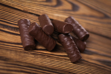 Heap of yummy chocolate candies on old weathered wooden table