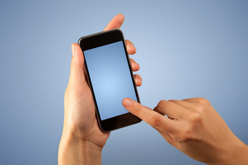 Female fingers touching blank smartphone